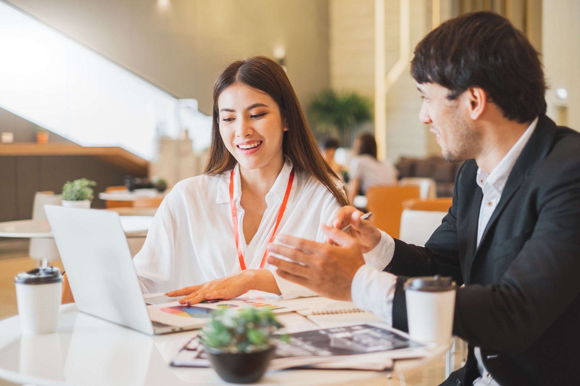 Young Asian business people and salesman broker discussing about insurance and financial investment planning in working office